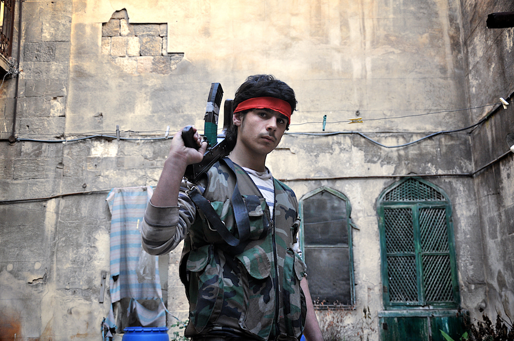 Ali, 18, poses for a photograph at the frontlines of Aleppo. D90